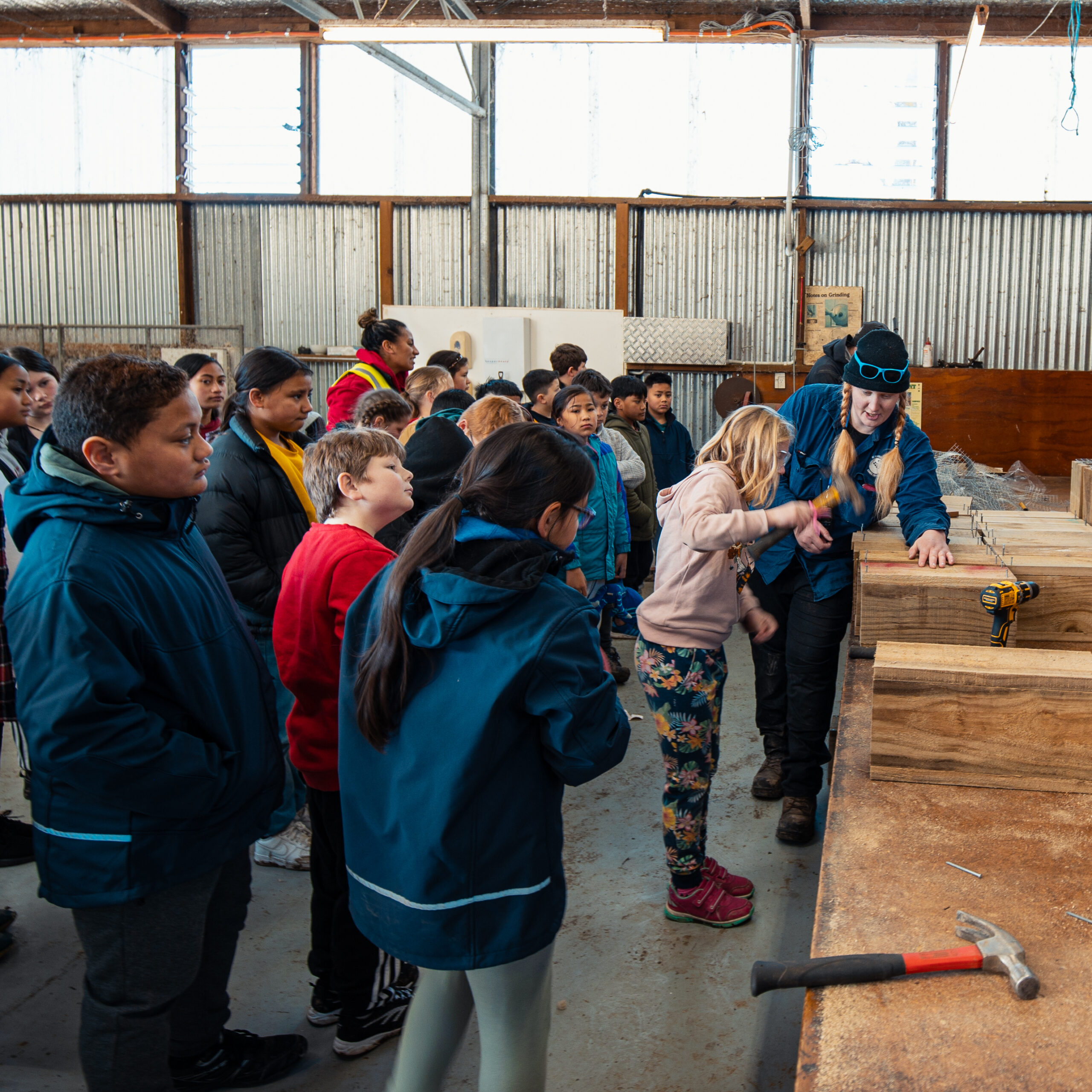 Group of school children learning to make a trap