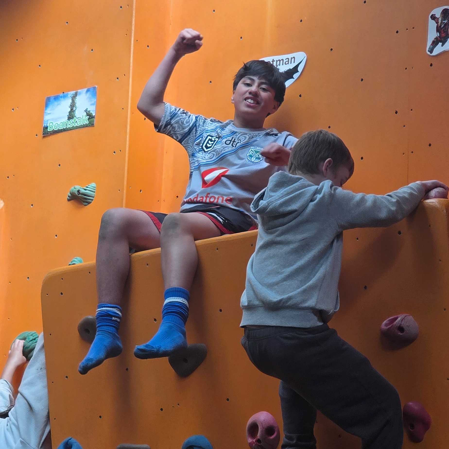 2 kids on a climbing wall